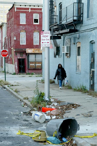 Martha Wallace, 35, takes a pleasant stroll down one of the neighborhood's dimly lit, trash-strewn streets.